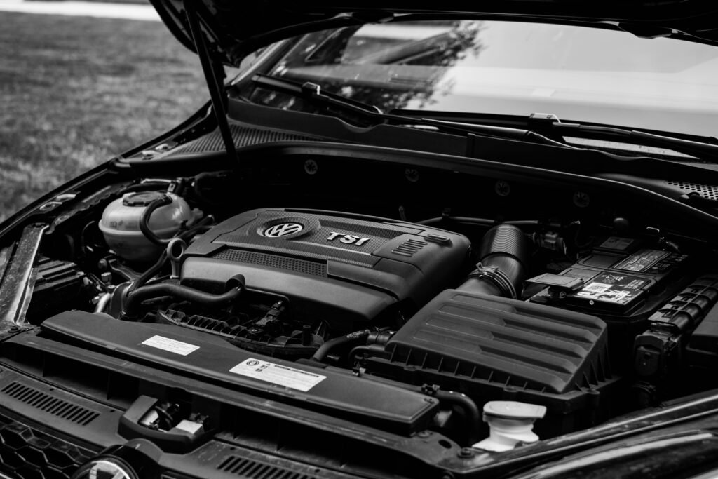 Mechanic inspecting a German car engine bay during German auto repair in Broward County