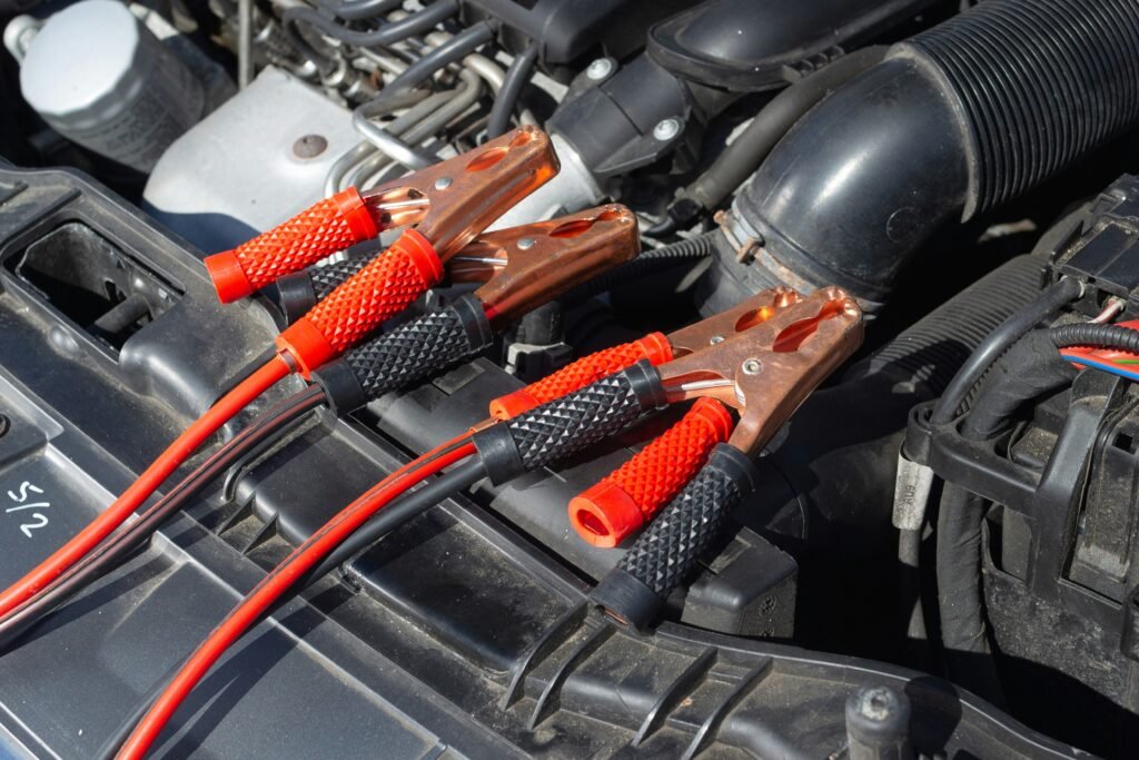 Technician testing a car battery and cables under the hood during a car battery replacement in Southwest Ranches, FL