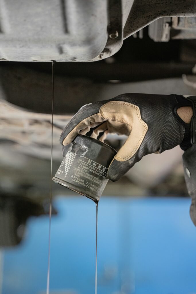 A technician pouring fresh fluid into a reservoir under the hood during a brake fluid flush in Southwest Ranches, FL