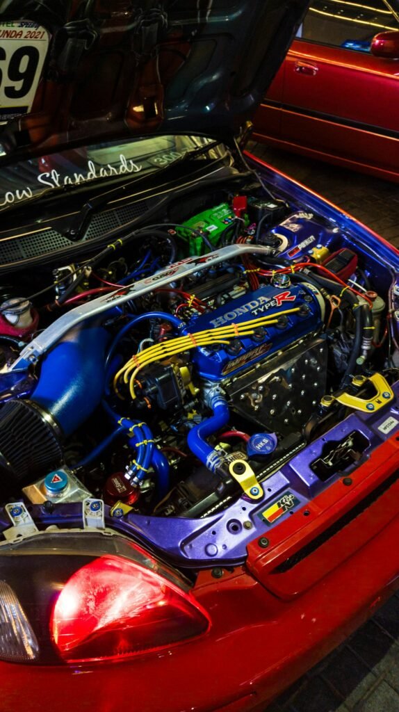 Highly modified engine bay with the hood open during one of the custom car builds we take on in Broward County