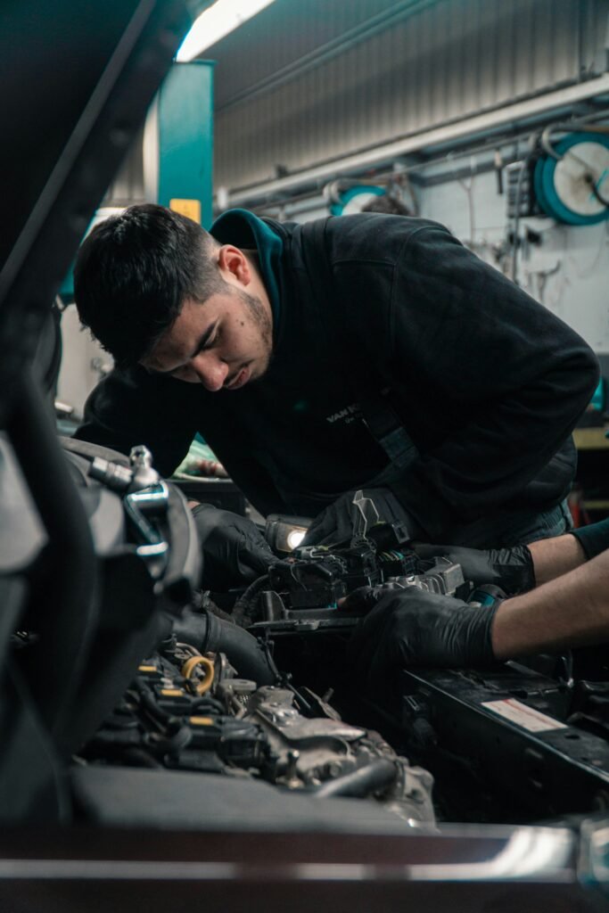 Technician working on an engine during head gasket repair in Weston, FL