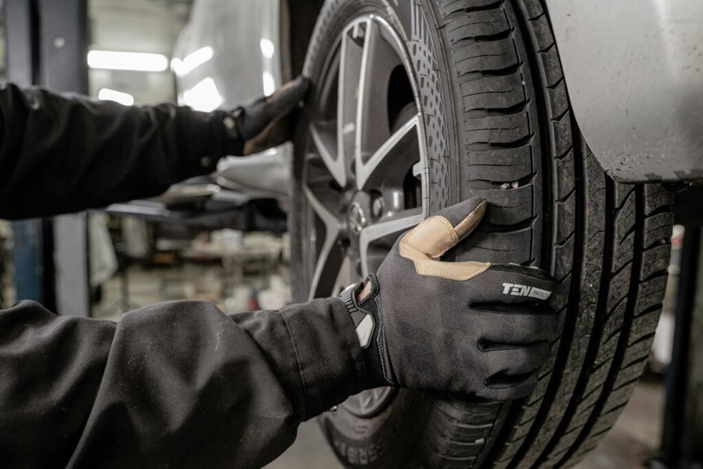 Technician servicing a wheel and tire during a wheel alignment in Cooper City, FL