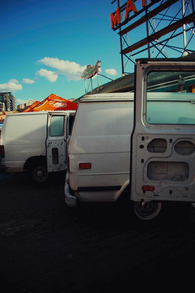 A row of white fleet work vans parked in a lot, the kind of vehicles covered by fleet maintenance in Broward County