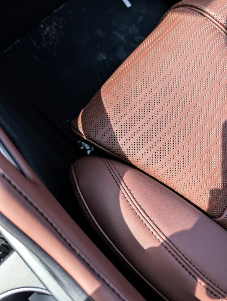 Perforated leather car seat with contrast stitching, the kind of cabin surface handled in car interior repair in Plantation, FL